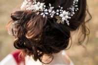 24 curled wedding updo with a statement vine of sheer and white beads and gold leaves