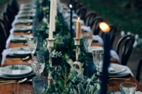 26 moody table setting with greenery and black candles can fit maquerade theme