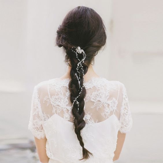 a messy braid with a crystal and pearl hair vine