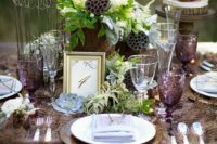 30 woodland table setting with a feather table runner, greenery, lotus, wood slices and succulents