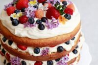 31 naked wedding cake with flowers and ripe summer berries
