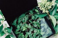32 clear acrylic wedding invites in a black velvet box with leaves inside