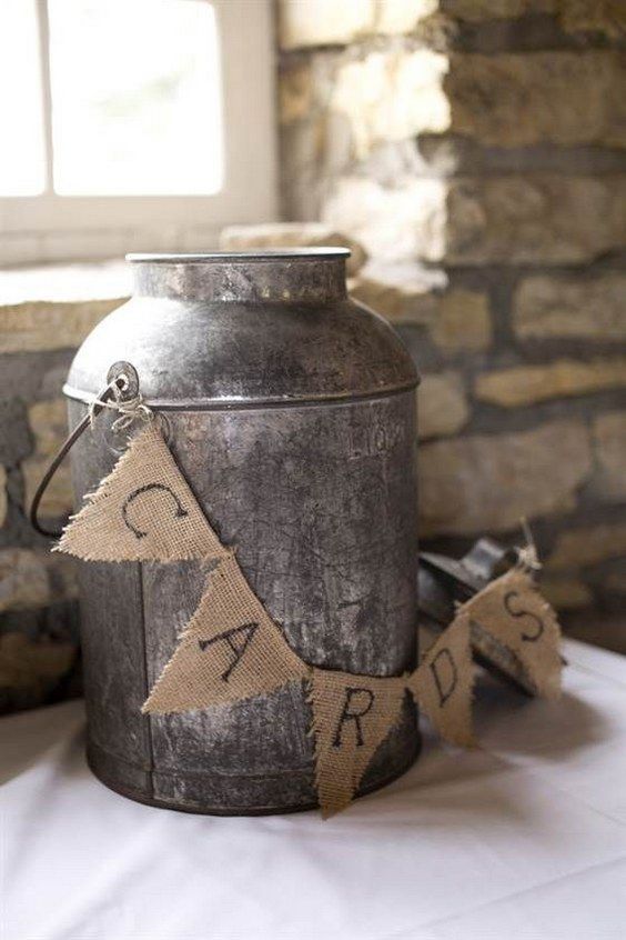 metal milk charn decorated with a burlap banner