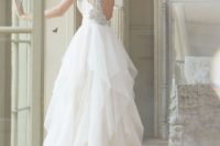 33 wedding dress with a heavily embellished circle cutout back and a draped tulel skirt