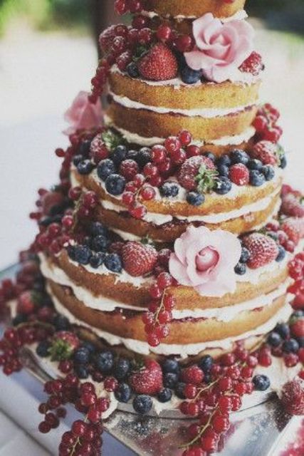 naked wedding cake with ripe berris and flowers