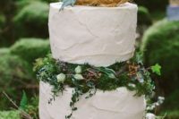 35 white frosted wedding cake with moss, greenery and blooms