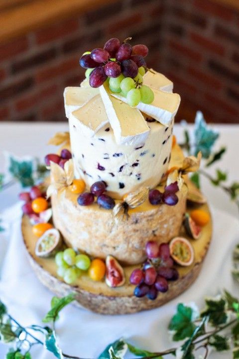 a cute and small cheese tower with fresh grapes