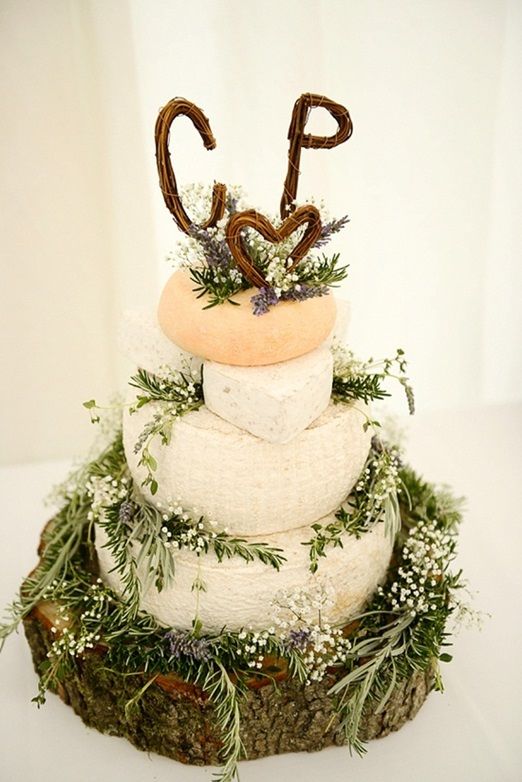 a wild and natural cheese wedding cake decorated with garden grown lavender and herbs, wicker letter toppers