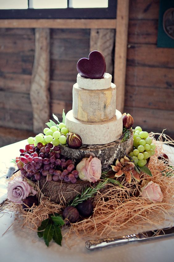 beautiful cheese tower with grapes and figs, a cheddar heart on top