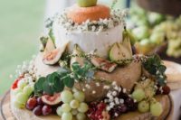 cute cheese tower with baby’s breath, eucalyptus, grapes and pears
