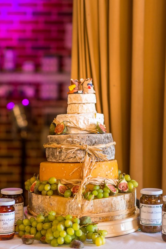 rustic cheese tower with straw, grapes, figs and mouse toppers