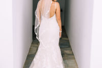 02 The bride was wearing a spaghetti strap backless dress with a small train and a veil