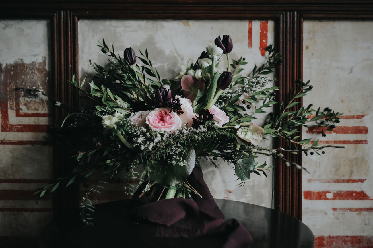 The wedding bouquet was textural, with lots of greenery, pink blooms and dark purple tulips