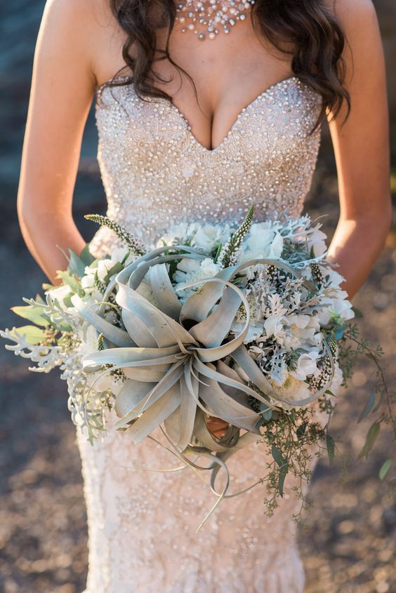 a beach inspired bouquet with air plants, white flowers and pale greenery