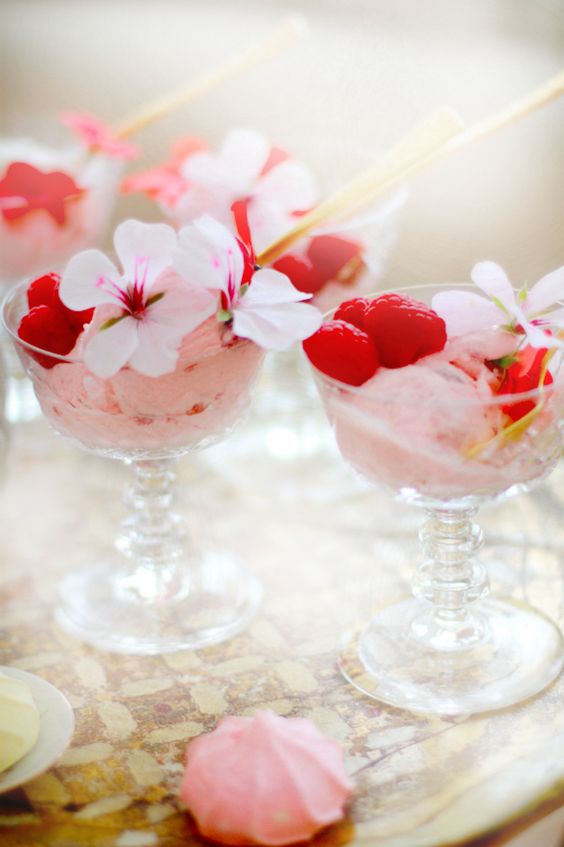 strawberry ice cream served topped with raspberries and flowers