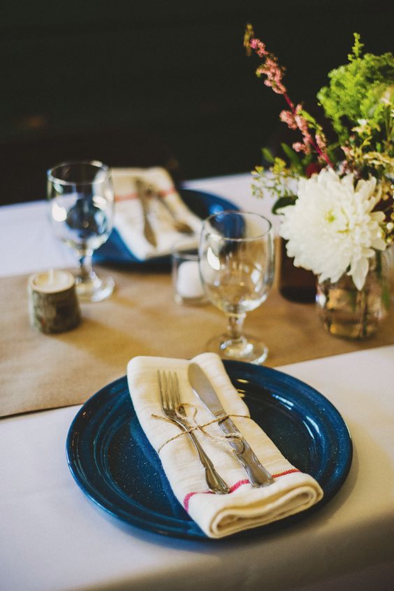 a rustic table runner, blue dishes and simple florals