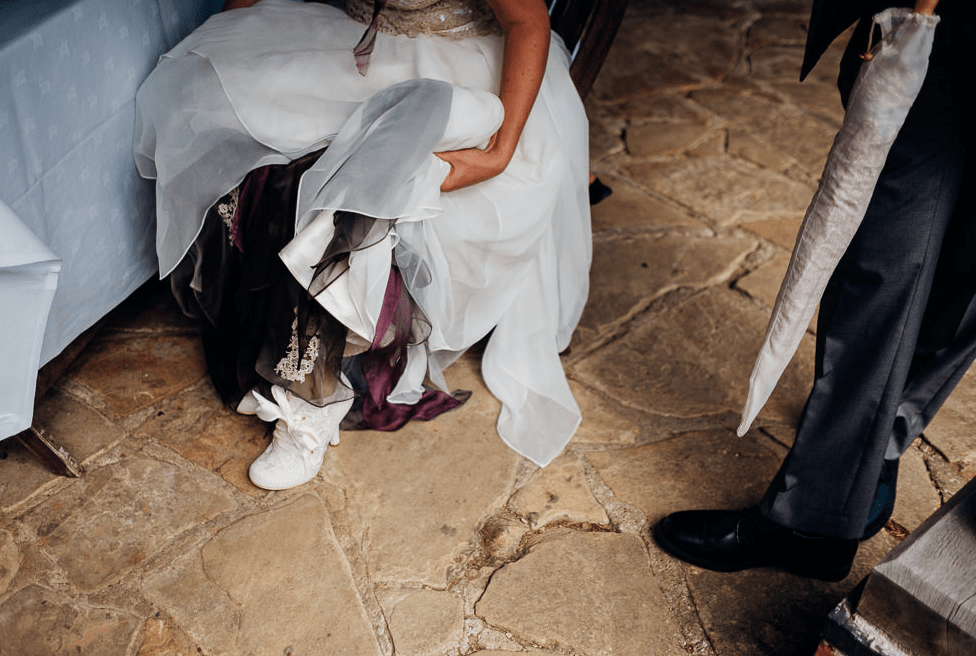 The bride was wearing white lacey boots with ribbon for a vintage touch