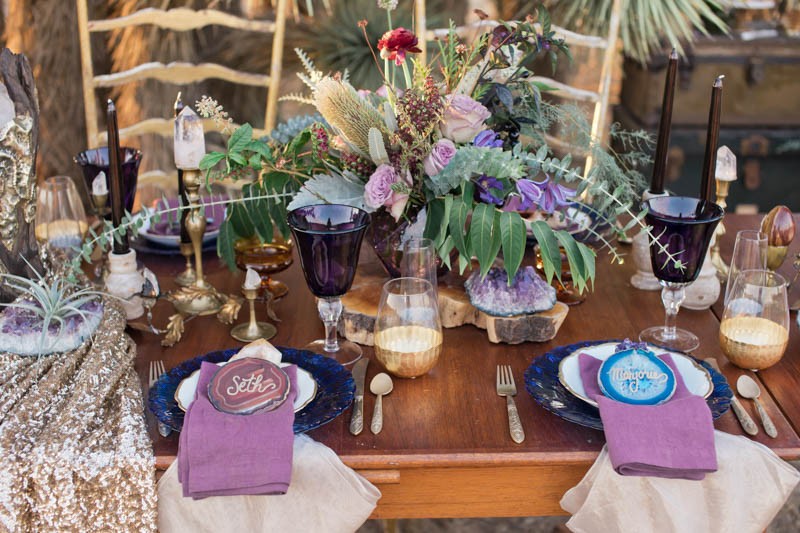 The wedding tablescape was rather bold, with a lilac and red flower centerpiece