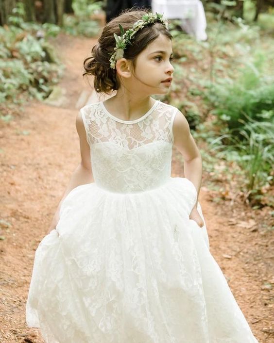 an ivory lace dress with an illusion neckline and a greenery crown