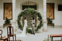 06 The wedding backdrop was an oversized greenery wreath, which is a popular trend today