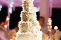 06 The wedding cake was textural and white with coconut and displayed with white florals