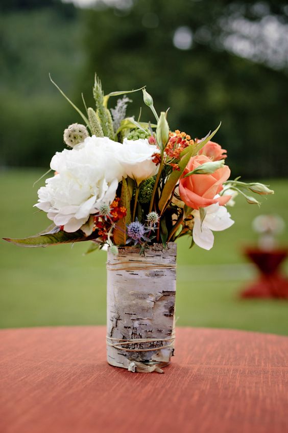 wrap vases with birch bark to give the arrangements a rustic look