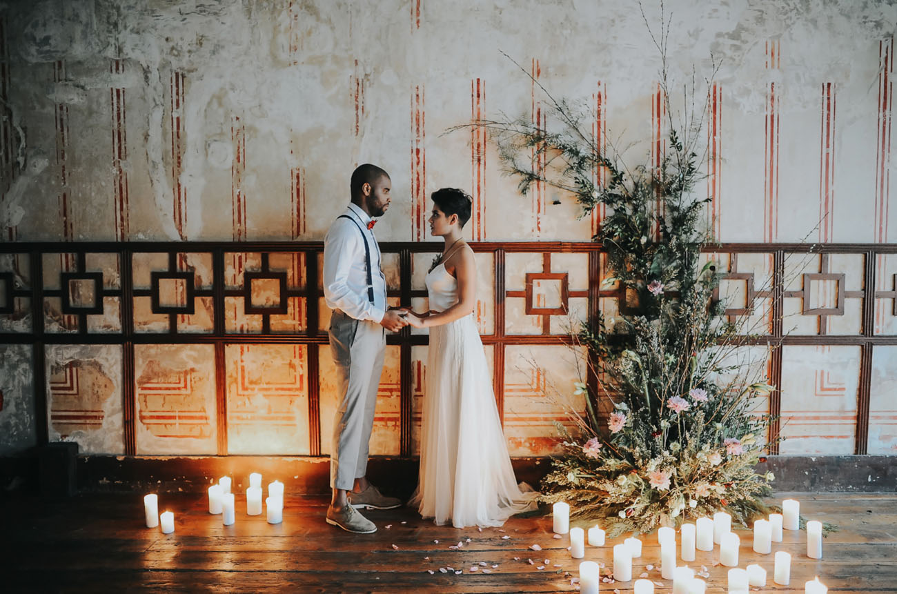 The ceremony space was industrial yet softened with greenery, flowers and lots of candles