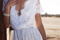 07 a white lace romper with short sleeves and a deep V cut is sexy and comfy