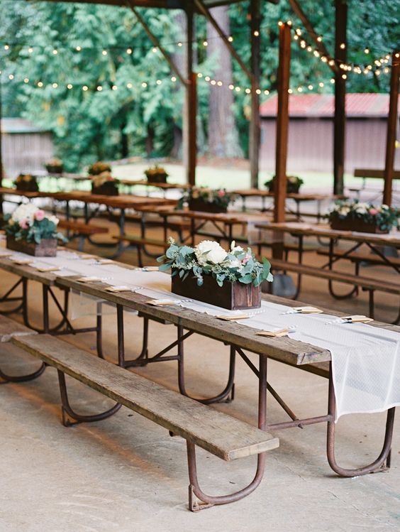 simple rustic benches and tables with floral box centerpieces