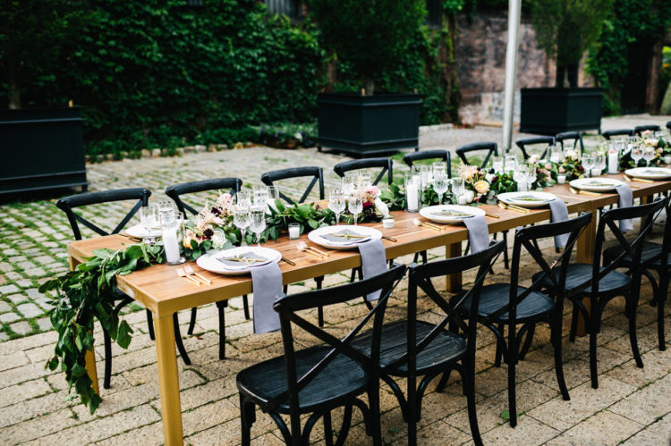 The tables were decorated with lush floral garlands and candles