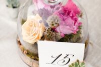 08 a cloche with moss and bold flowers, a paper table number attached