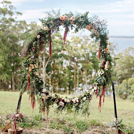 fall boho giant wreath with lots of greenery and blush and burgundy flowers