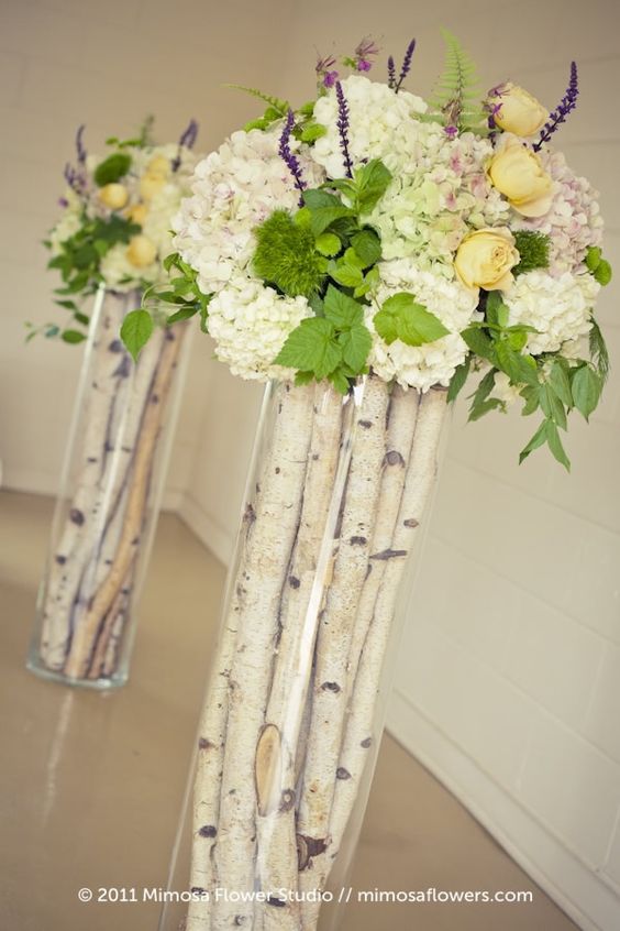 birch sticks in tall vases and fresh flowers on top for cool compositions
