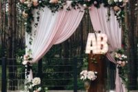 10 cute altar with pink curtains, pink and blush flowers, candles and marquee letters