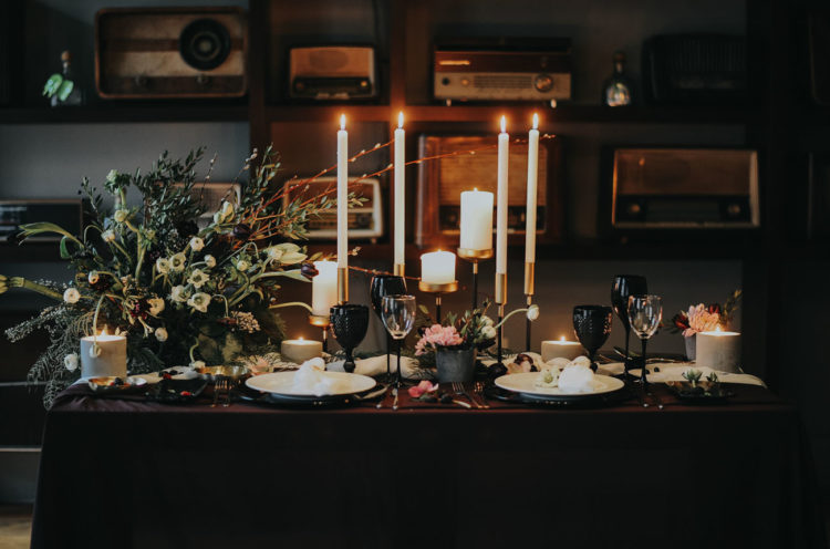 The sweetheart table was a dramatic one, with a textural floral centerpiece, candles, black glasses