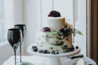12 The textural wedding cake was topped with leaves, berries and dark purple blooms