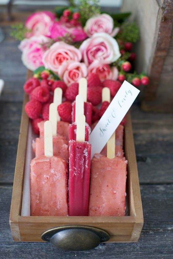 berry popsicles in a box and fresh raspberries