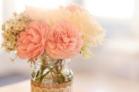 13 a mason jar wrapped with burlap and lace with blush and neutral flowers