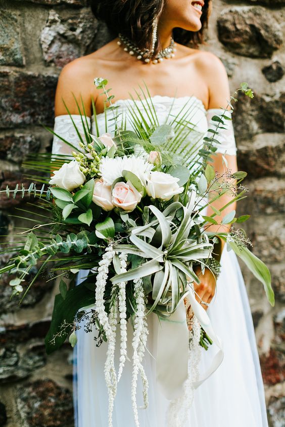 an eye-catchy tropical-inspired bouquet with blush roses, eucalyptus, air plants and greenery