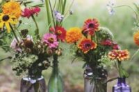 13 colored glass bottle vases with wildflowers will be a nice and centerpiece