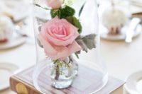 13 vintage books and pink roses in a cloche is a refined idea