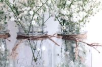 14 transparent mason jars with twine and baby’s breath are ideal for centerpieces