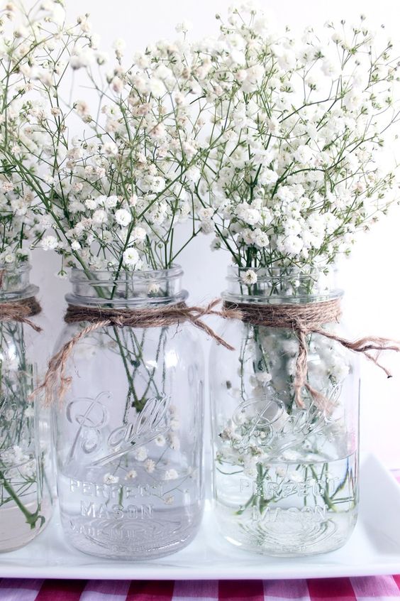 transparent mason jars with twine and baby's breath are ideal for centerpieces
