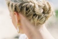 16 a braided updo with a hairpiece in the center looks chic