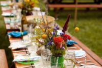 16 colorful table setting with wildflowers and bold dishes