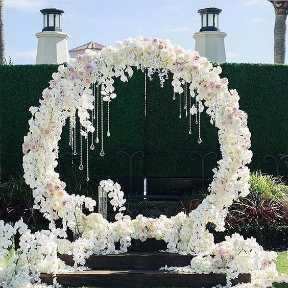 white and blush flower wreath with crystals hanging for a glam feel