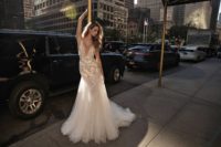 18 A plunging neckline wedding dress with lace appliques and a light mermaid silhouette, a tulle skirt