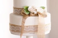 19 a white cake decorated with burlap and lace