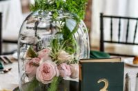 20 a cloche with blush peonies and greenery on top