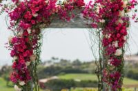 20 the wedding arch covered in fuchsia and white bougainvillea